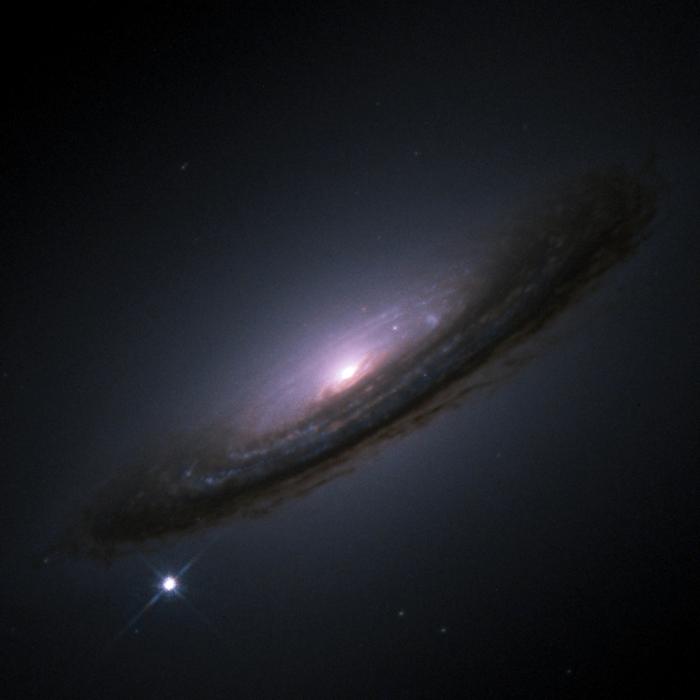 Researchers used type Ia supernovae, similar to SN1994d pictured in its host galaxy NGC4526, to help establish that the universe’s expansion may actually have started to slow.