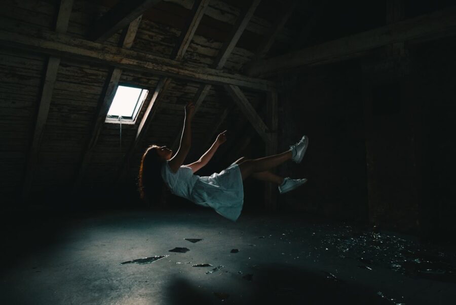 cheerleader levitating in an attic