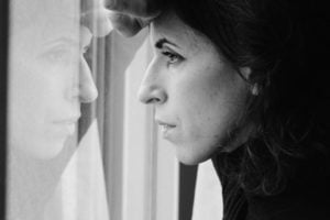 Depressed woman looking out window