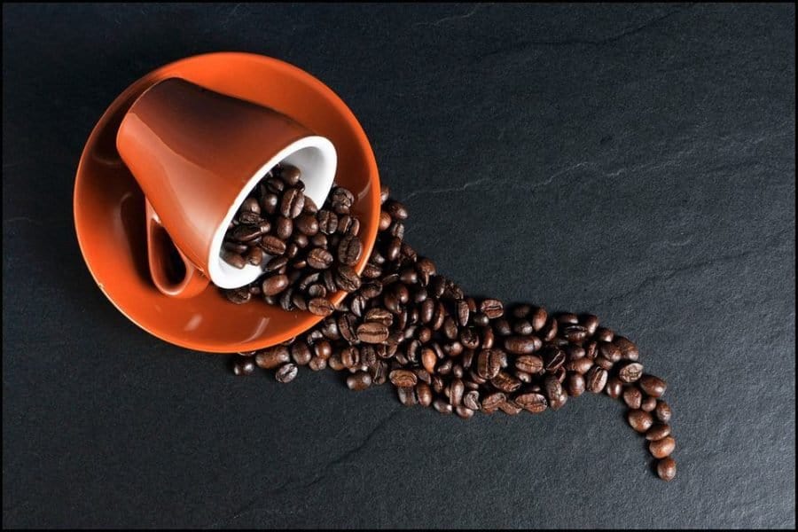 Coffee cup with beans spilling out