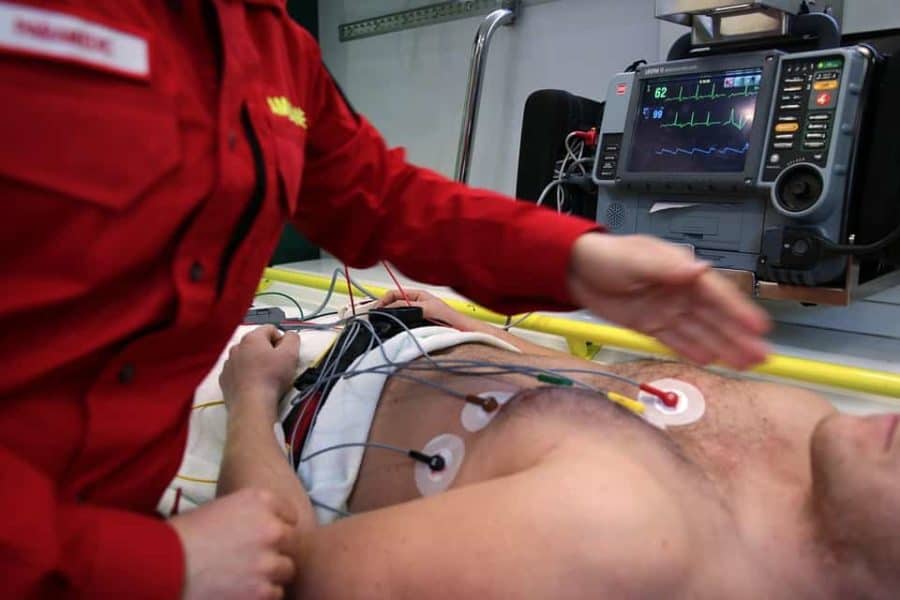 Man in ambulance hooked up to heart monitor