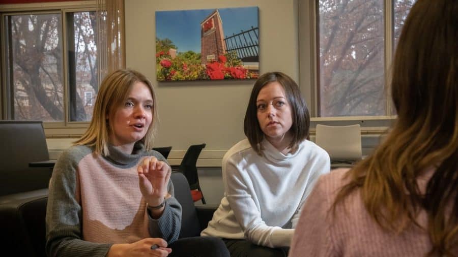 Rebecca Brock (center), assistant professor of psychology, and graduate student Frannie Calkins (left), interview a student. Their latest research suggests that even well-intentioned, healthy support — being helpful, encouraging and a good listener — can be counterproductive.