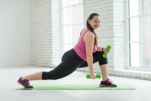 woman exercising with light weight dumbells