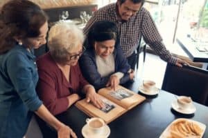 Vietnamese senior people watching old photos in photo