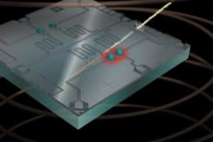 In this artistic rendering, a high-energy cosmic ray hits the qubit chip, freeing up charge in the chip substrate that disrupts the state of neighboring qubits. IMAGE COURTESY OF ROBERT MCDERMOTT