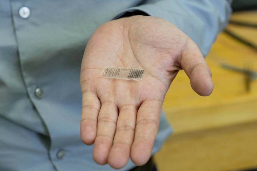 UW–Madison Professor Xudong Wang holds a fracture electrostimulation device he and his lab designed. When placed over a fracture, the device generates electricity from movement, accelerating bone healing. JASON DALEY