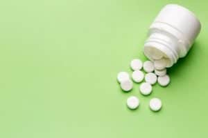 white pills on a green background