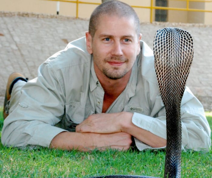 Associate Professor Bryan Fry faces off with a cobra at The University of Queensland.