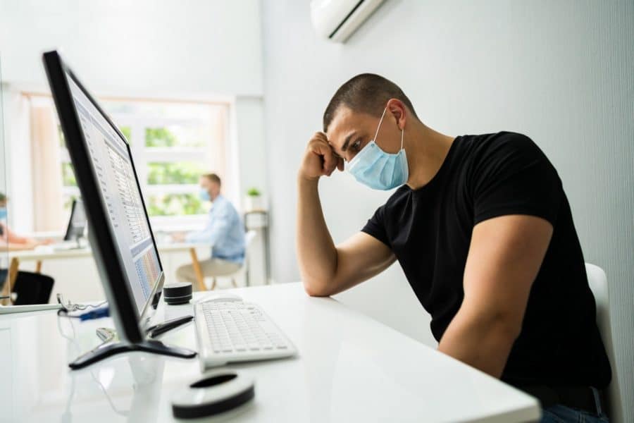 Stressed man in a surgical mask