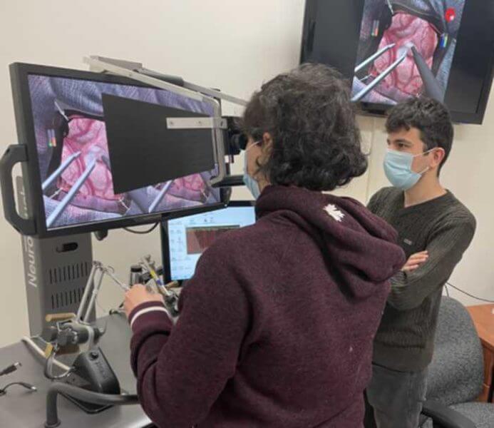 A student training on a neurosurgical simulator.