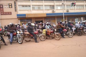 Motorcycle taxis, known as boda bodas, wait on the side of the road in Kampala, Uganda.