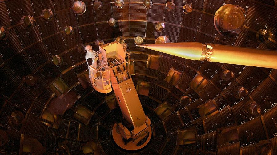 A technician works at the National Ignition Facility. Scientists used the array of 196 lasers to create conditions similar to the hot gas inside gigantic galaxy clusters.