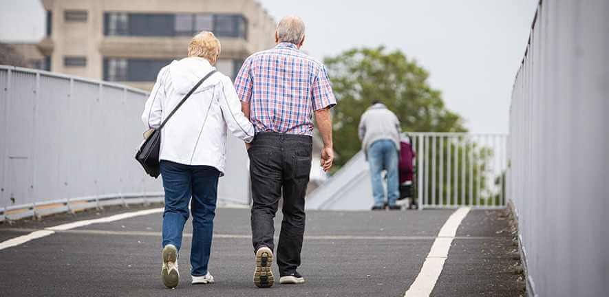 An elderly couple walking together