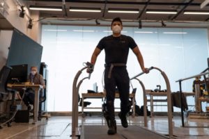 Leo Medrano, a PhD student in the Neurobionics Lab at the University of Michigan, tests out an ankle exoskeleton on a two-track treadmill. By allowing the user to directly manipulate the exoskeleton’s settings while testing it on a treadmill, preferences that are difficult to detect or measure, such as comfort, could be accounted for by the users themselves. Image credit: University of Michigan Robotics Institute