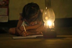 A child studies by lantern light. Globally, 1.2 billion people live without access to electricity. (Image credit: Triloks/iStock)