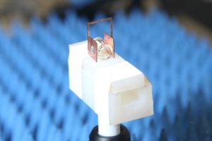 Copper “headphones” boost the sensitivity of NIST’s atomic radio receiver, which is composed of a gas of cesium atoms prepared in a special state inside the glass container. When an antenna located above the setup sends down a radio signal, the headphones boost the strength of the received signal a hundredfold.