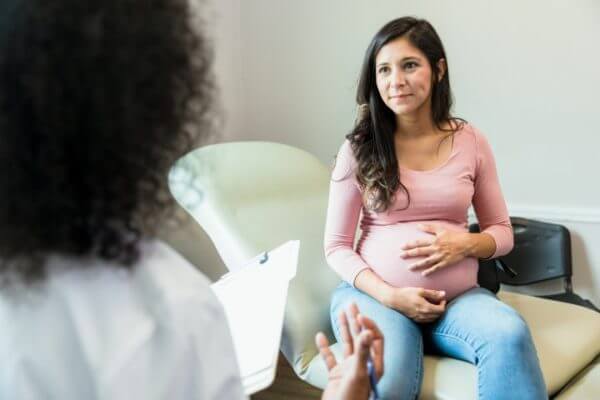 Pregnant woman with doctor