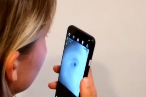 A smartphone user can image the eye using the RGB selfie camera and the front-facing near-infrared camera included for facial recognition. Measurements from this imaging could be used to assess the user’s cognitive condition. Credit: Digital Health Lab