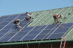 solar panels being installed on a building