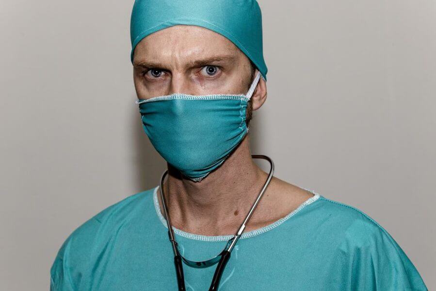A physician in a surgical mask