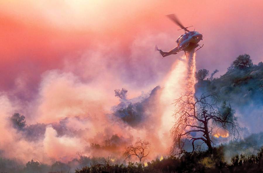 helicopter dropping chemicals on wildfire