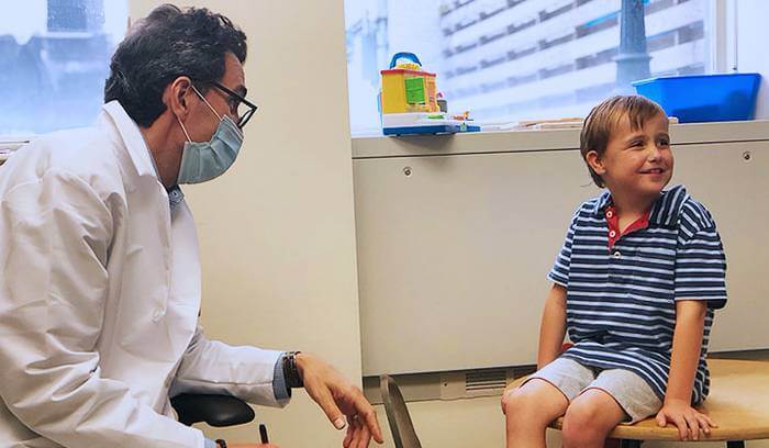Dr. Alexander Kolevzon, Clinical Director of the Seaver Autism Center for Research and Treatment at Mount Sinai with trial participant.