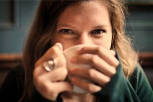 Woman smiling with coffee mug