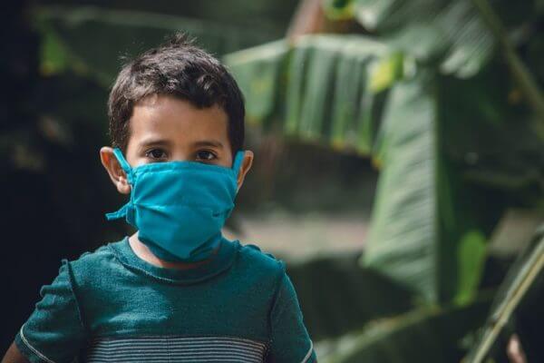 Child wearing a mask to protect against Covid.