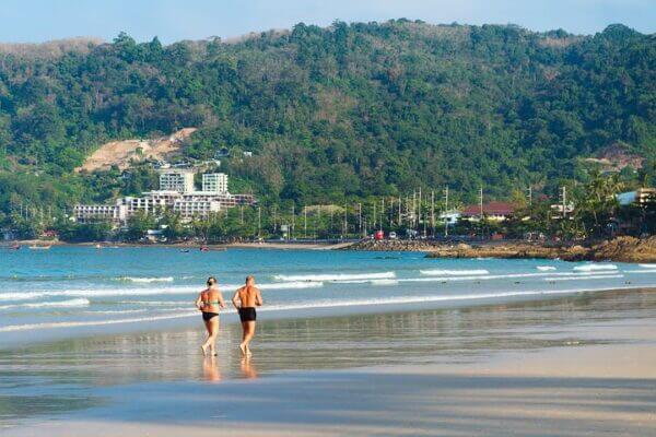 Older couple running on beach