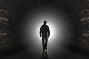 Conspiracy illustration of a man in shadows in a long tunnel