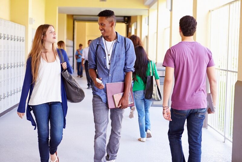 Students walking in high school hallway