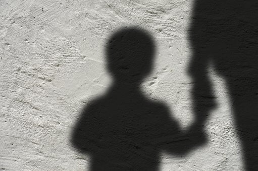 Photo of a child's shadow on cement