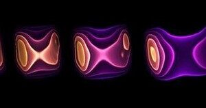 This graphic shows the energy density (yellow is high; purple is low) at different times during the hydrodynamic evolution of matter created in a collision of a lead ion (moving to the left) with a photon emitted from another lead ion (moving to the right