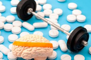Illustration of weight lifting equipment, brain and pills