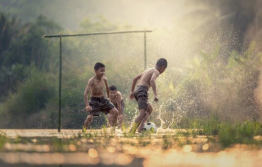 Children playing soccer/football.