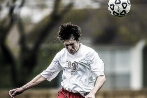 football soccer player heading a ball