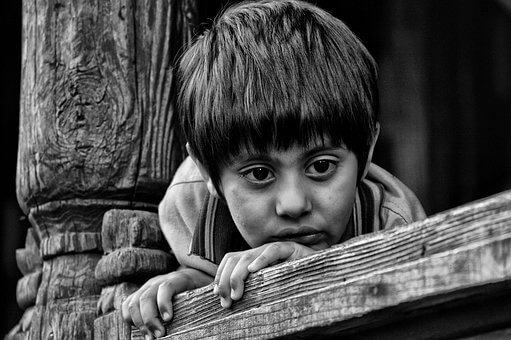 Young boy looking forlorn