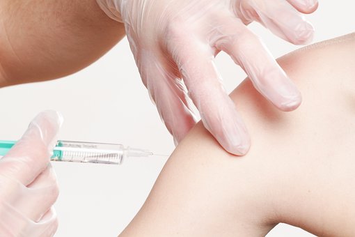 An arm receiving a vaccination