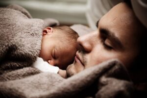 Baby and father snuggling