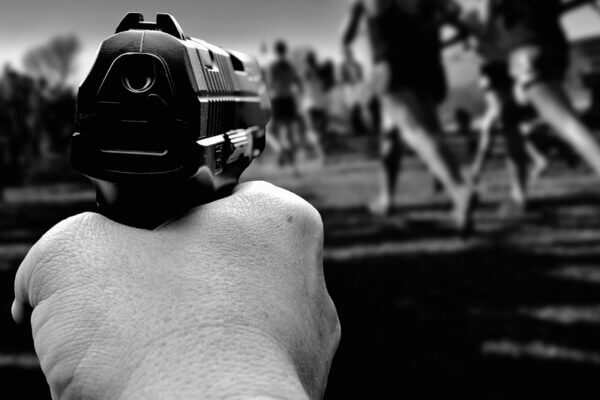 Hand pointing gun at runners