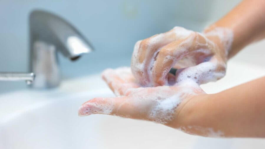 Person washing their hands.