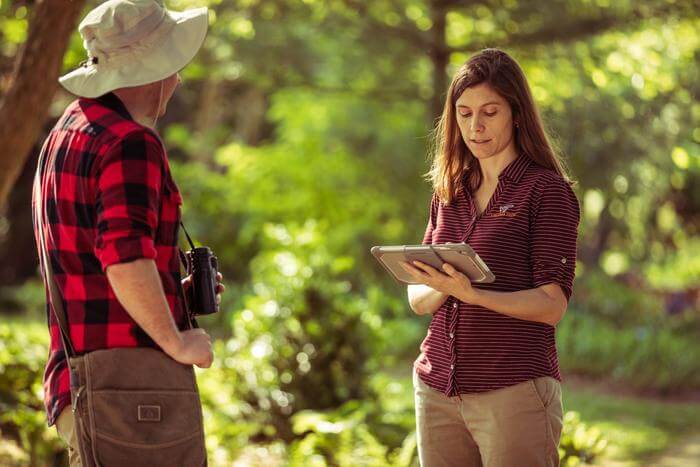 Ashley Dayer (right) conducts a survey in the field.