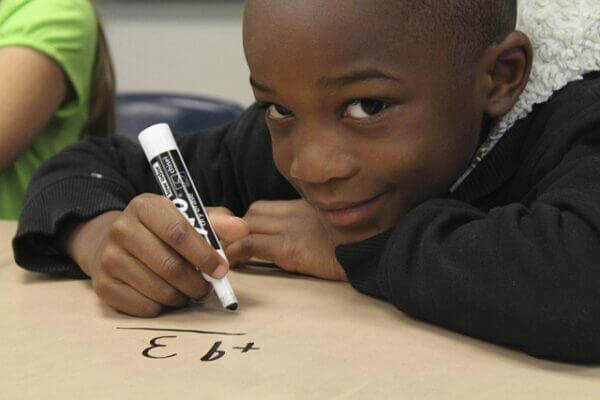 Young boy doing math. credit pixabay