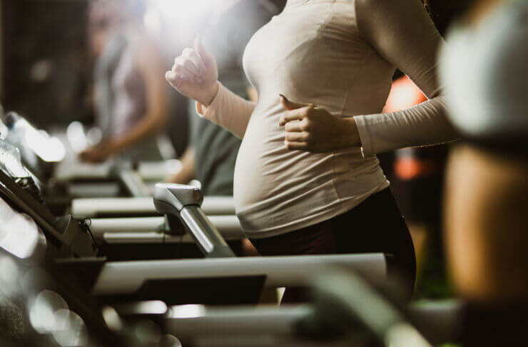 Pregnant woman jogging on a treadmill