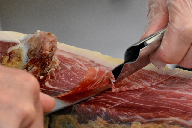 Ham being thinly carved