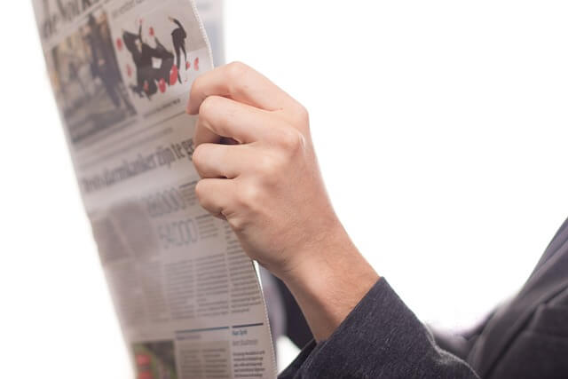 Hands holding a newspaper. Pixabay.