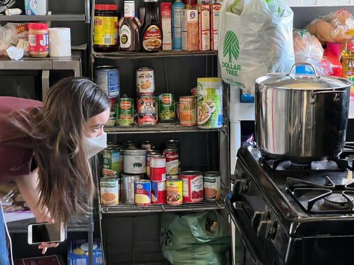 Woman cooking in front of gas stove