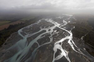 Freshwater bodies like this braided river in New Zealand are among those that researchers measured with water-level sensors and GPS during validation efforts for the international SWOT satellite, which launched in December. Credit: Alyssa LaFaro, UNC Research