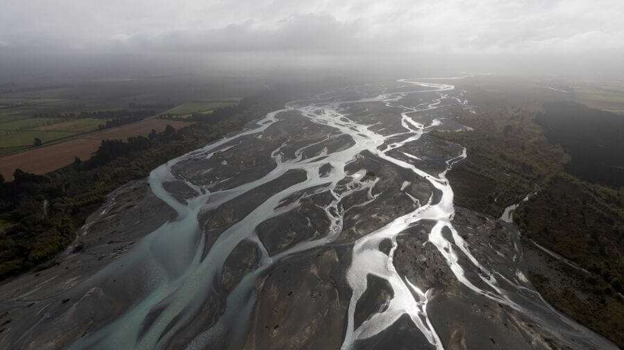 Freshwater bodies like this braided river in New Zealand are among those that researchers measured with water-level sensors and GPS during validation efforts for the international SWOT satellite, which launched in December. Credit: Alyssa LaFaro, UNC Research