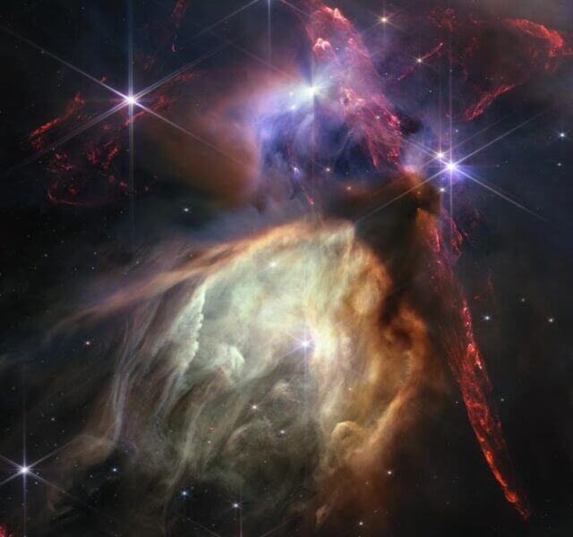 The first anniversary image from NASA’s James Webb Space Telescope displays star birth like it’s never been seen before, full of detailed, impressionistic texture. The subject is the Rho Ophiuchi cloud complex, the closest star-forming region to Earth. It is a relatively small, quiet stellar nursery, but you’d never know it from Webb’s chaotic close-up. Jets bursting from young stars crisscross the image, impacting the surrounding interstellar gas and lighting up molecular hydrogen, shown in red. Some stars display the telltale shadow of a circumstellar disk, the makings of future planetary systems. Download the full-resolution, uncompressed version and supporting visuals from the Space Telescope Science Institute: https://webbtelescope.org/contents/media/images/2023/128/01H449193V5Q4Q6GFBKXAZ3S03?news=true